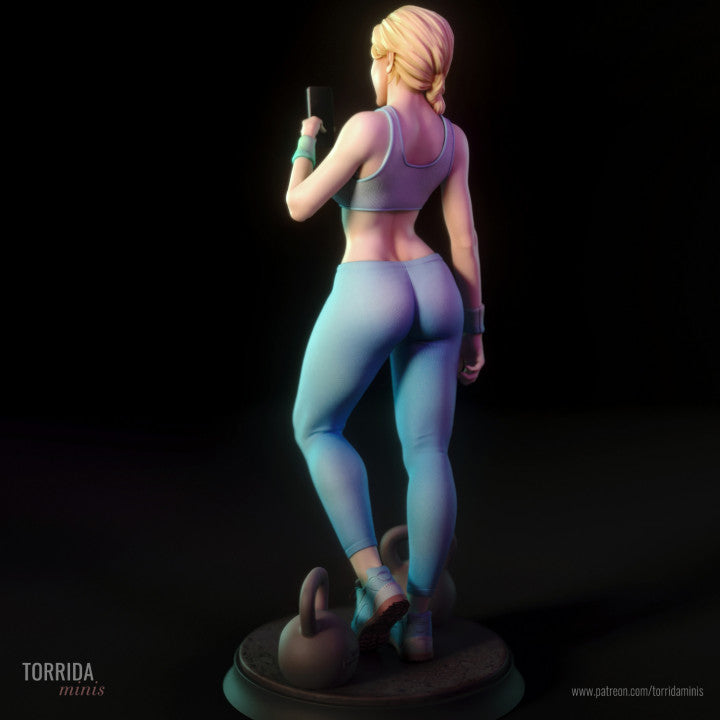 Statue of a woman in athletic wear with weights on a dark background.