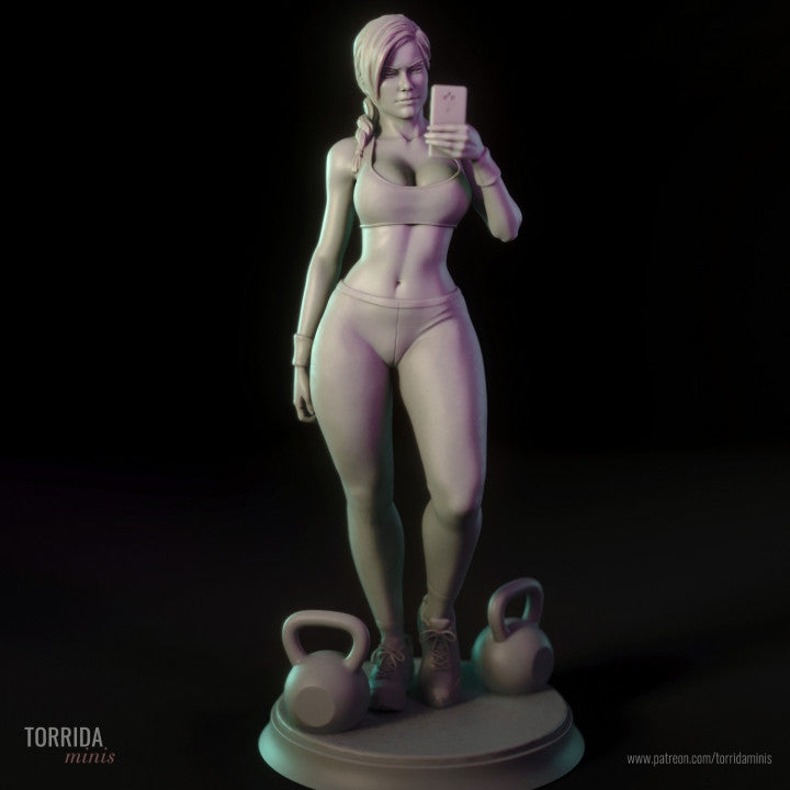 Statue of a woman in athletic wear with kettlebells on a dark background.