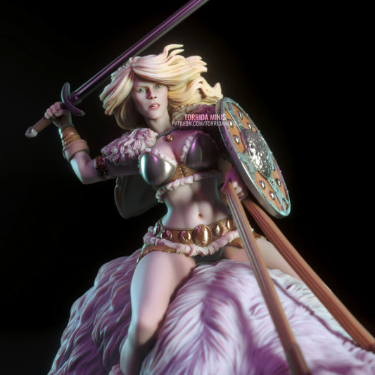 Close-up of female barbarian-style rider with flowing blonde hair, metal bikini armour, and round painted shield. Fantasy art resin figure with expressive sculpting.